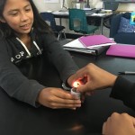 Two students working together to build a flashlight.